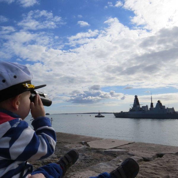 Harry (2), pictured in the Little Troopers 2020 calendar waving goodbye to his Dad's ship in Portsmouth harbour